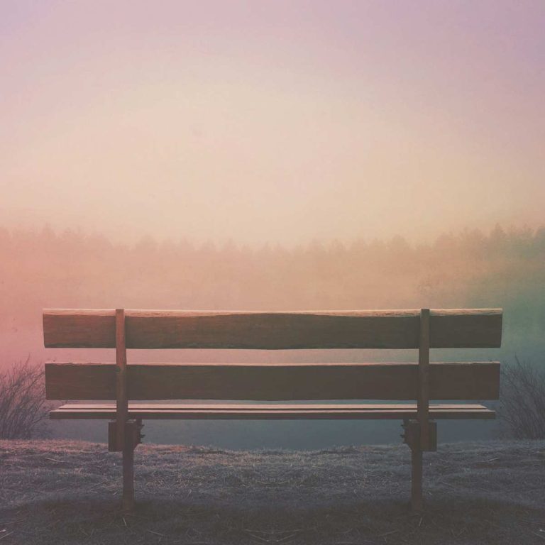 empty bench overlooking a valley