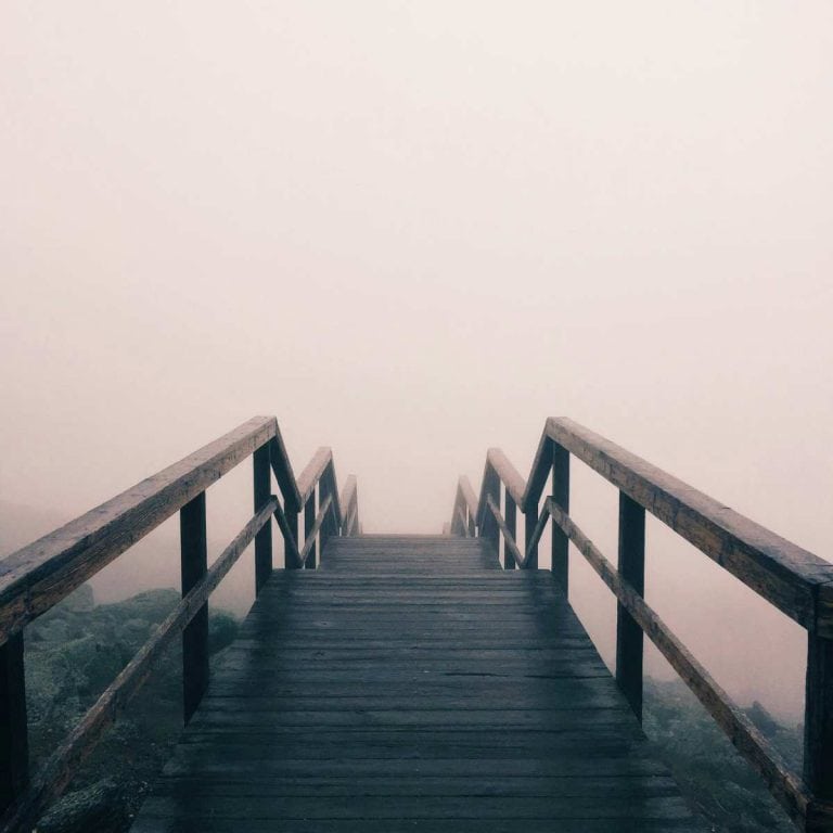 foggy air behind a wooden bridge