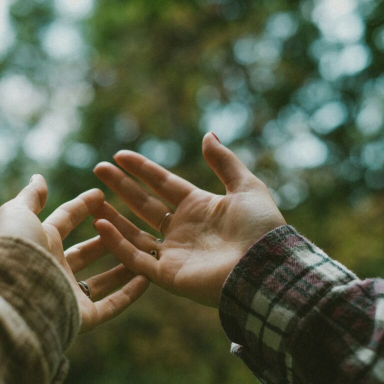 two hands connecting at fingertips